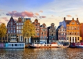 Amsterdam Netherlands dancing houses over river Amstel landmark in old european city spring landscape.