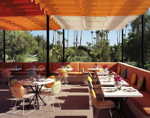 Colorful orange decor on Norma's outdoor patio at the Parker Palm Springs Hotel