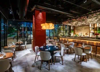 Interior of Mita with floor to ceiling windows and a sophisticated bar