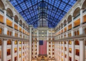 The Romanesque Revival property features a light-filled nine-story atrium and a historic clock tower. Photo Credit: Waldorf Astoria, Washington, D.C.