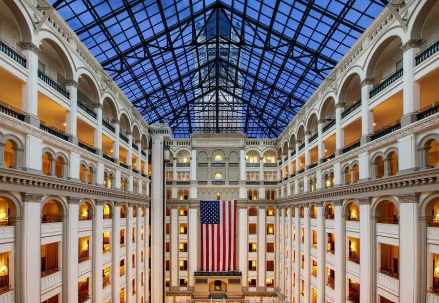 The Romanesque Revival property features a light-filled nine-story atrium and a historic clock tower. Photo Credit: Waldorf Astoria, Washington, D.C.
